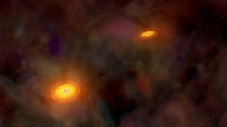 Ilustración de dos agujeros negros supermasivos.