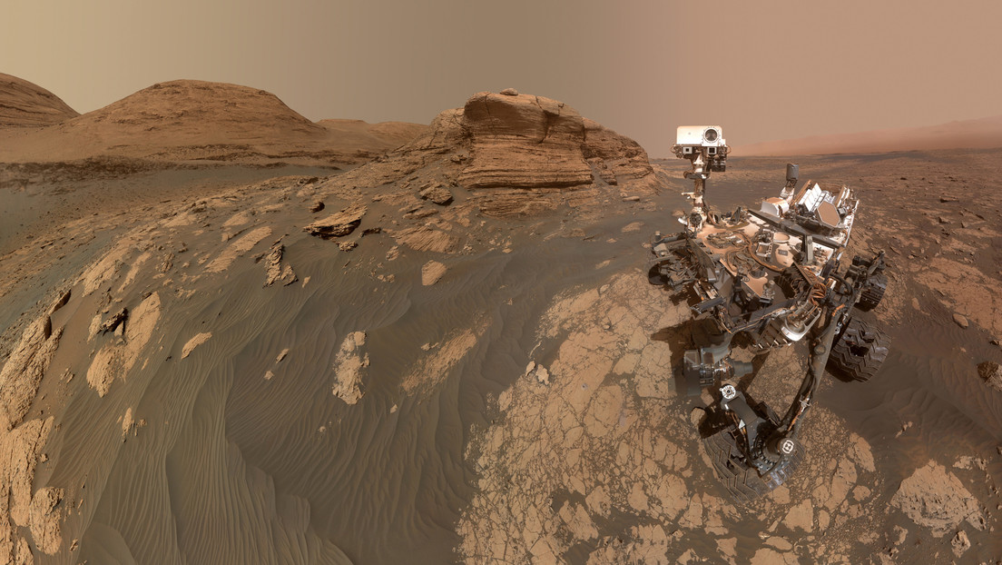 NASA's Curiosity Rover takes a selfie next to a majestic rock formation on Mars