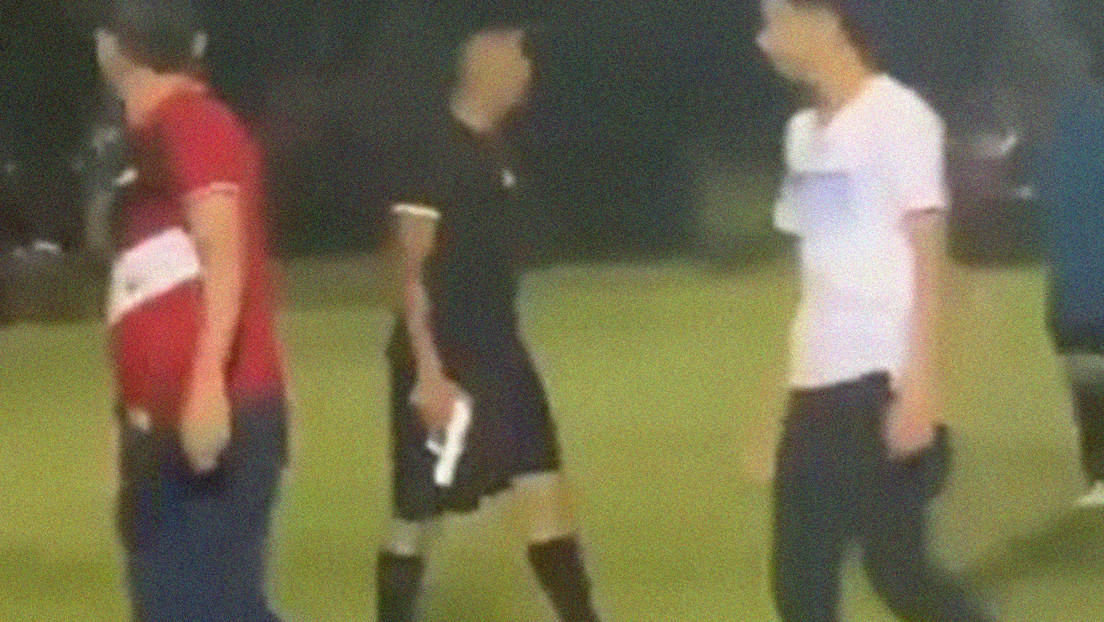 VIDEO: A referee pulls out a gun to stop a group of players and fans from lynching him