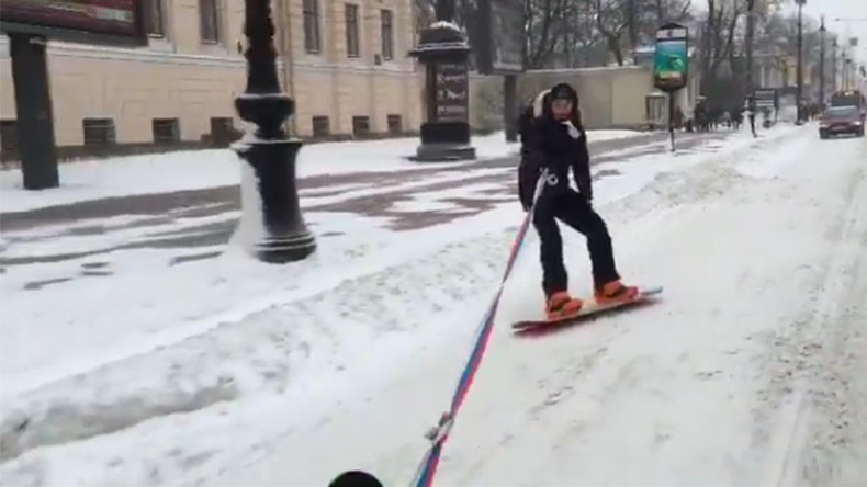 Hitchin’ a ride: Snowboarder pulled by car shows off tricks in icy St. Petersburg (VIDEO)