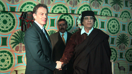 British Prime Minister Tony Blair (L) shakes hands with Libyan leader Muammar Gaddafi in a tent outside Tripoli, March 25. 2004. © Madeleine Chambers