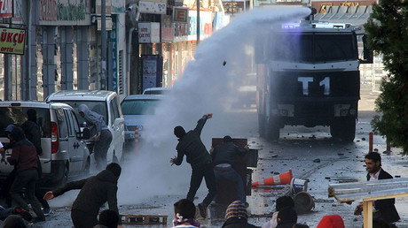 Riot police use a water cannon to disperse stone throwing Kurdish demonstrators during a protest against the curfew in Sur district, in the southeastern city of Diyarbakir, Turkey, December 22, 2015. © Sertac Kayar
