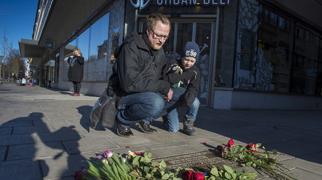 A man and his son visit the site where former Social Democratic politician, statesman and prime minister Olof Palme was assasinated, on the 30th anniversary of his assassination, at Sveavagen in central Stockholm, Sweden February 28, 2016. © Jonas Ekstromer