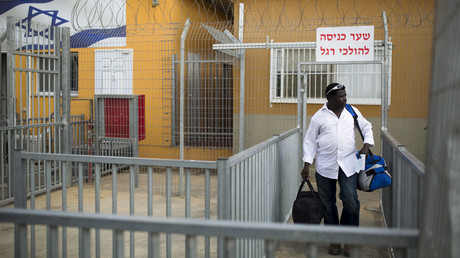 FILE PHOTO: An African migrant carries his luggage as he leaves Holot detention centre in Israel's southern Negev desert August 25, 2015. © Amir Cohen
