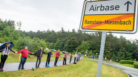 Activists attend a rally "Stop-Ramstein" on the road leading to US Air Force Base in Ramstein-Miesenbach on June 11, 2016. © Oliver Dietze / DPA
