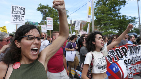 Demonstrators chant slogans during a march by various groups, including 
