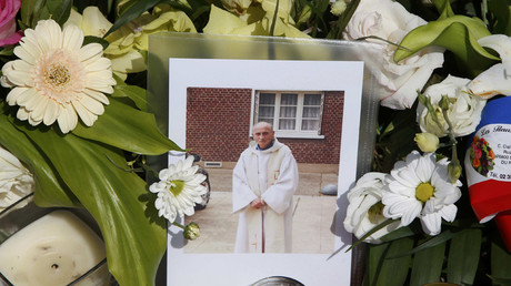 Flowers pay tribute to French priest Father Jacques Hamel outside the city hall in Saint-Etienne-du-Rouvray, near Rouen, France, July 28, 2016. © Pascal Rossignol