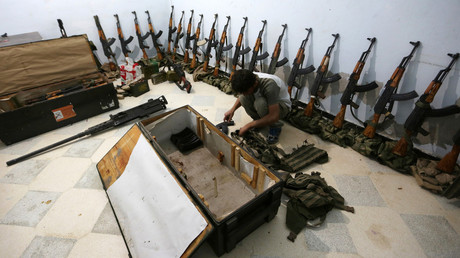A rebel fighter of 'Al-Sultan Murad' brigade arranges weapons inside a warehouse in the northern Syrian rebel-controlled town of al-Rai, in Aleppo Governorate, Syria, September 26, 2016. © Khalil Ashawi