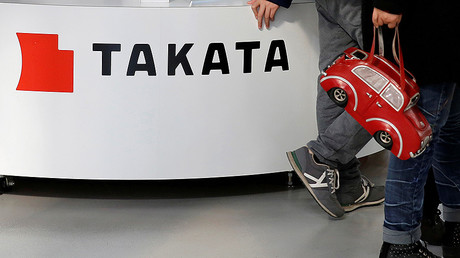 Visitors walk past a logo of Takata Corp on its display at a showroom for vehicles in Tokyo, Japan. © Toru Hanai