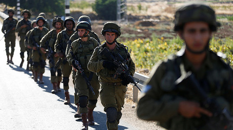 Israeli soldiers provide security during a protest against the killing of two settlers by Palestinians in two separate attacks, near the Jewish settlement of Otniel in the West Bank, July 10, 2016. © Baz Ratner