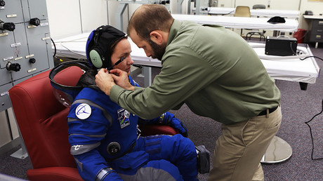 A suit technician fits the communications carrier on an astronaut stand-in before pressurizing the spacesuit inside Crew Quarters at NASAKennedy Space Center in Florida © NASA / Cory Huston