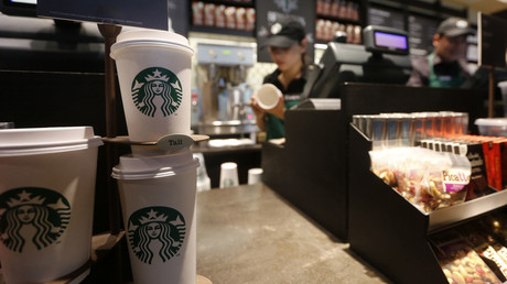 Paper cups of different sizes are seen on display at Starbucks store © John Vizcaino 