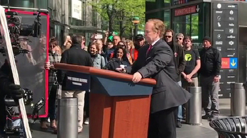 Melissa McCarthy rides Sean Spicer’s podium through New York streets