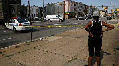 Resident in the neighborhood where Freddie Gray was arrested and where residents rioted over his death in April look on at the scene of a shooting in West Baltimore © Jim Bourg