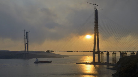 The sun sets behind a bridge under construction linking Russky Island (R) to the mainland, near Russia's far Eastern port of Vladivostok © Yuri Maltsev