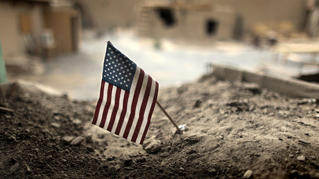 FILE PHOTO: An American flag is placed in a dirt-filled barrier, at Combat Outpost Nolen, north of Kandahar. © Bob Strong