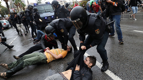 Spanish Civil Guard officers remove demonstrators outside a polling station for the banned independence referendum in Barcelona, Spain, October 1, 2017. © Susana Vera