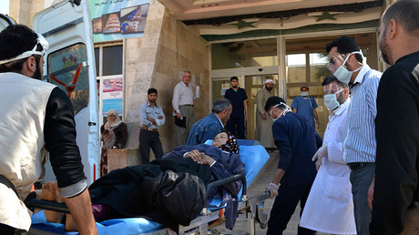 FILE PHOTO: A woman affected by what activists say was a gas attack on the town of Telminnes is transferred to Bab al-Hawa hospital, Syria on April 21, 2014 © Reuters