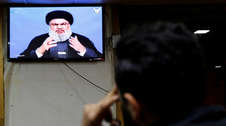 FILE PHOTO:  A man watches Lebanon's Hezbollah leader Sayyed Hassan Nasrallah © Jamal Saidi