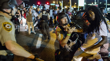 St Louis County police officers hold an anti-police demonstrator in Ferguson, Missouri August 10, 2015. © Lucas Jackson