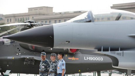 FILE PHOTO: Chinese Soldiers stand next to a J-10 fighter jet. © Jason Lee