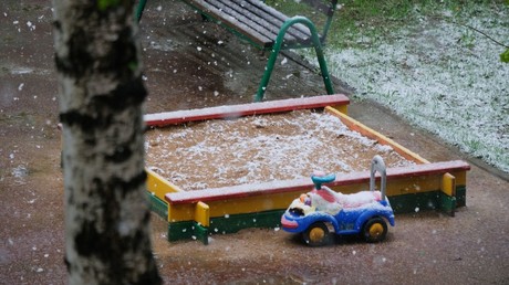 Children's playground on a Moscow street during a snowfall © Natalia Seliverstova