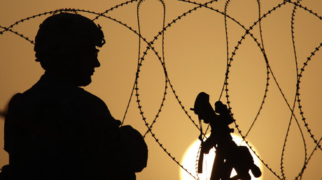 A US soldier keeps watch at sunset north of Kandahar, July 18, 2010 / Bob Strong 