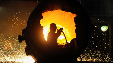 FILE PHOTO: A worker operates a furnace at a steel plant in Hefei, Anhui province August 18, 2013 © Jianan Yu 