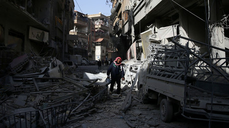 A man walks on the rubble of damaged buildings at the besieged town of Douma, Eastern Ghouta, Damascus. © Bassam Khabieh