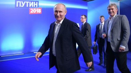 Russian President and presidential candidate Vladimir Putin visits his campaign headquarters. Right: Dmitry Peskov, presidential press secretary and deputy chief of the presidential executive office © Alexei Druzhinin