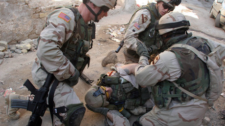 Feb 16, 2005 - Baghdad, Iraq - An American soldier with the 1st Cavalry Division is treated after being shot in the volatile area of the Haifa Street neighborhood. © Robert King