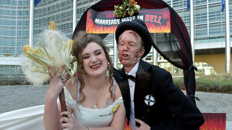 Activists from the environmental organization Friends of the Earth Europe stage a 'marriage made in hell' during an action in front of the European Commission against Bayer and Monsanto in Brussels © Eric Vidal