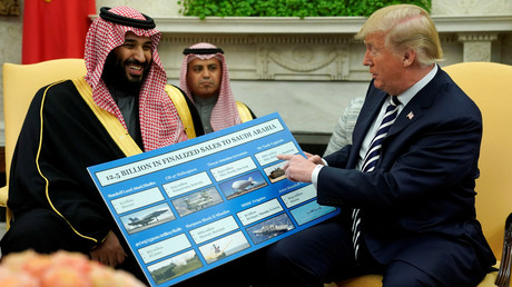 US President Donald Trump holds a chart of military hardware sales as he welcomes Saudi Arabia's Crown Prince Mohammed bin Salman, March 20, 2018 / Jonathan Ernst