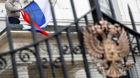 FILE PHOTO: A man takes the flag off the flagpole outside the consular section of Russia's Embassy in London © Phil Noble