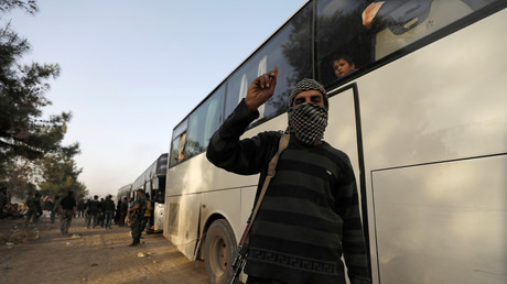 FILE PHOTO: Rebel fighter gestures as he stands next to a bus before evacuation outside Jobar, in Damascus, Syria  © Omar Sanadiki