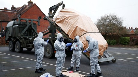 Soldiers wearing protective clothing remove a police vehicle from a car park in Salisbury, Britain on March 11, 2018. © Henry Nicholls