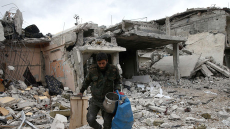 FILE PHOTO: A man walks on rubble of damaged buildings in the town of Douma, Eastern Ghouta  Bassam Khabieh