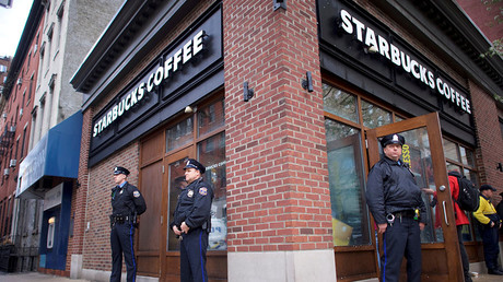 Police officers monitor activity outside as protestors demonstrate inside a Center City Starbucks, where two black men were arrested, in Philadelphia, US © Mark Makela
