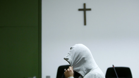 Cross on the wall of a Munich courtroom during a trial of a suspected Islamic State member in January 2015 © Michaela Rehle