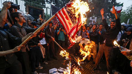 Iranians burn US flags during an anti-US demonstration outside the former US embassy headquarters in the capital Tehran on May 9, 2018. © Atta Kenare