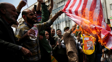 Iranians burn a US flag during a protest in Tehran, Iran, May 11, 2018. © Tasnim News Agency
