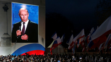 Russian president Vladimir Putin addresses the audience during a rally marking the anniversary of Crimea's reunification with Russia © Maxim Shemetov