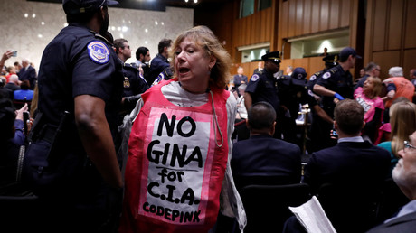 A demonstrator is ejected prior to CIA Director nominee Gina Haspel testifying at her confirmation hearing May 9, 2018. © Aaron P. Bernstein