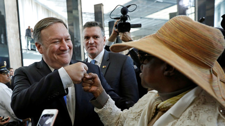 New United States Secretary of State Mike Pompeo fist bumps with a woman upon his arrival during his first day at the State Department in Washington, U.S., May 1, 2018. © Kevin Lamarque