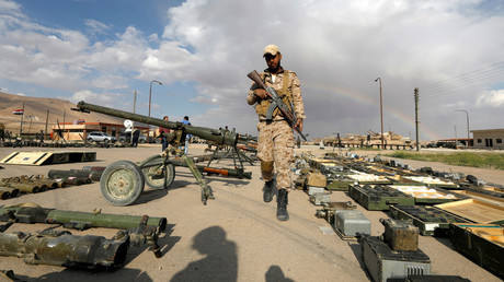 А Syrian soldier surveys weapons surrendered by rebels from Eastern Qalamoun, Syria April 22, 2018. © Omar Sanadiki