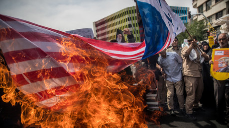 Iranians burn a US flag during a protest against President Trump's decision to pull out of the nuclear deal. © Reuters