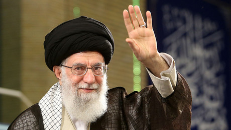 Ayatollah Ali Khamenei waving to the crowd as he delivers a speech during Labor Day at the workers' meeting on April 30, 2018