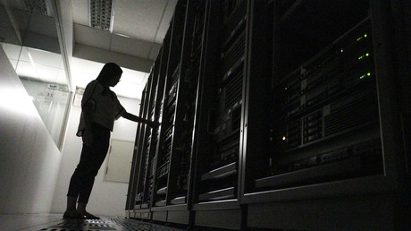An employee works inside a server room © Athit Perawongmetha