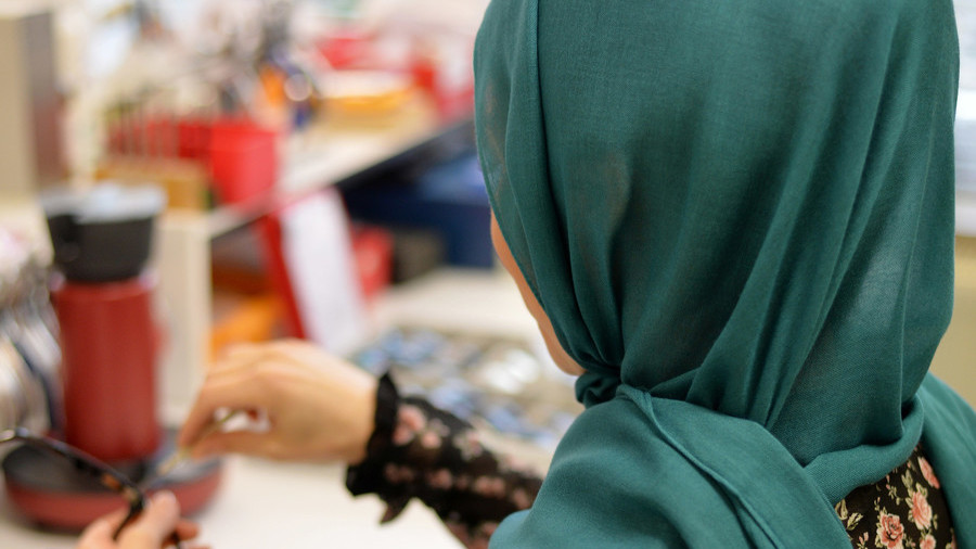Calls for police action after video posted of man spraying stain remover at Muslim woman