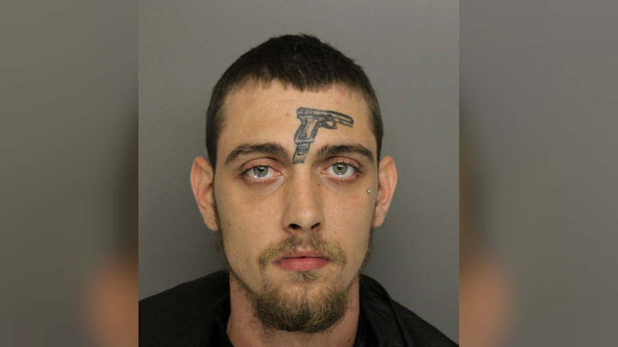 Selffulfilling prophecy? Man with gun tattoo on face